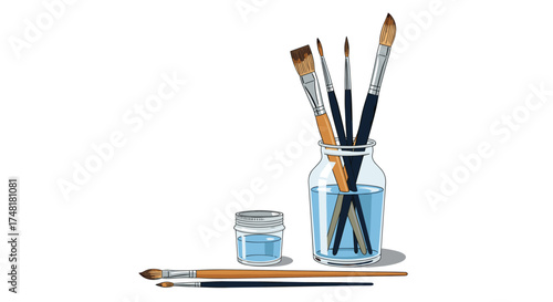 A collection of art brushes rests in a glass jar filled with blue liquid.