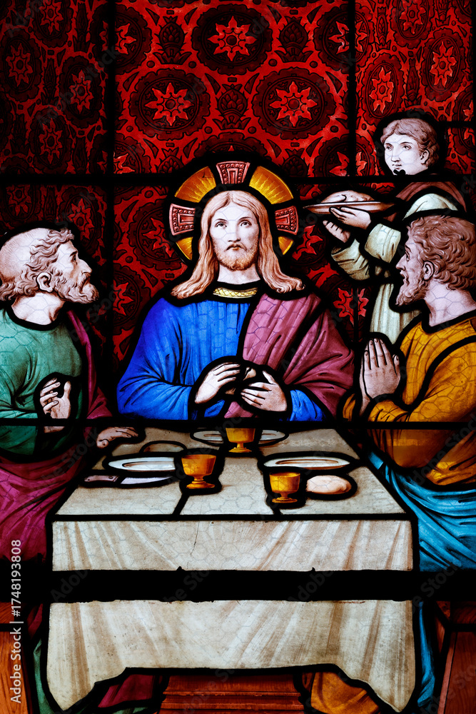 Fototapeta premium Saint Seine church. Stained glass. The Supper at Emmaus was one of the occasions when Jesus revealed himself to his followers after his Crucifixion and Resurrection. Corbigny. France.