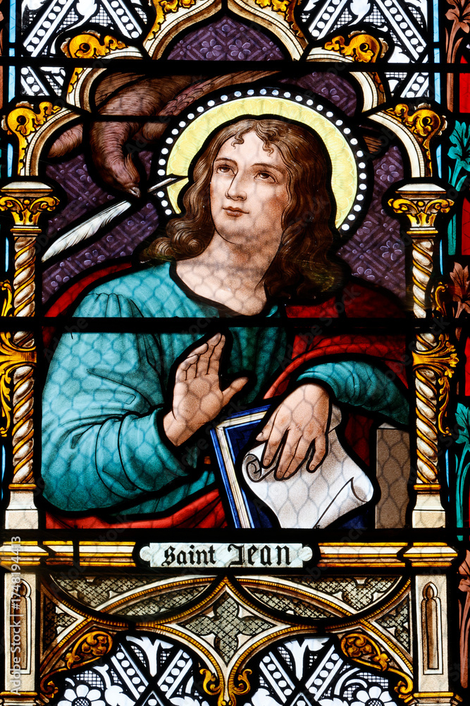 Fototapeta premium Saint Laurent church. Stained glass. John is traditionally depicted with an eagle, symbolizing divinity and the lofty nature of his Gospel. Tavernay. France.