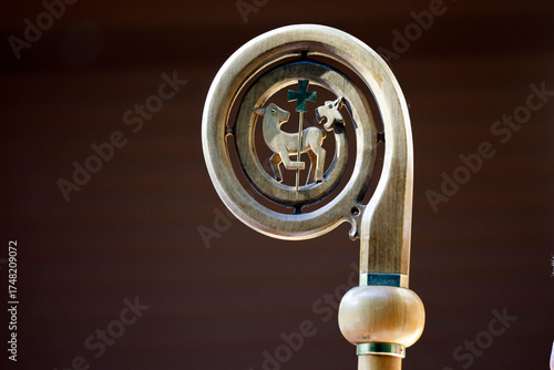 Bishop’s wooden crozier with stylized Lamb of God and cross, symbol of episcopal authority and Christ. La Roche sur Foron.  France.