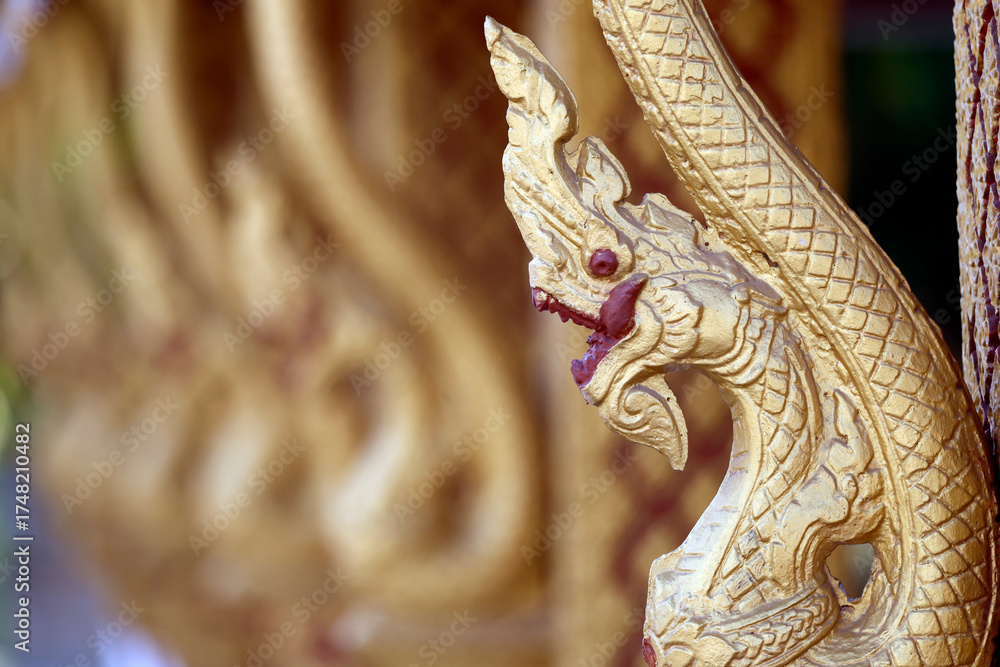 Fototapeta premium Wat Phramahathat Rajbovoravihane buddhist temple. Traditional buddhist golden dragon sculptures. Luang Prabang. Laos.