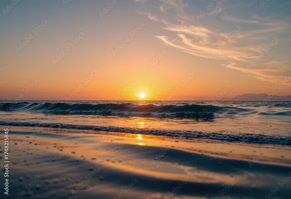 Fototapeta premium Sunset over ocean waves with glowing horizon and soft clouds