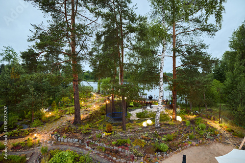 A Serene and Tranquil Lakeside Garden Featuring Beautiful Pine Trees and Soft Lighting