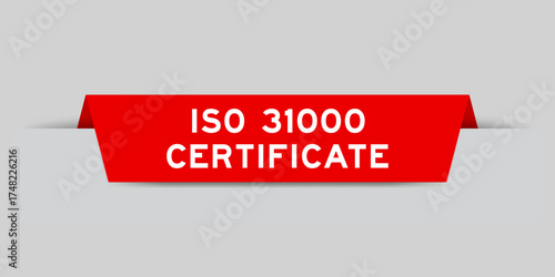 Red color inserted label with word ISO 31000 certificate on gray background