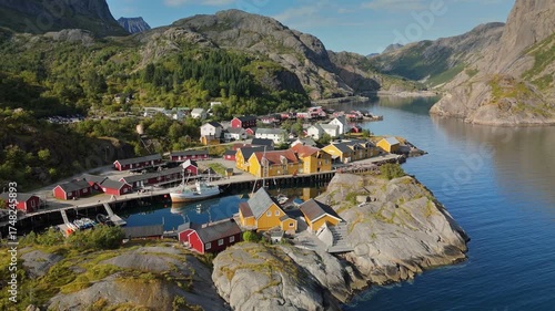 Aerial shot of famous Nusfjord fishing villgae, Lofoten Islands, Norway. Discover the stunning coastal village with colorful houses nestled between mountains and water in northern Norway