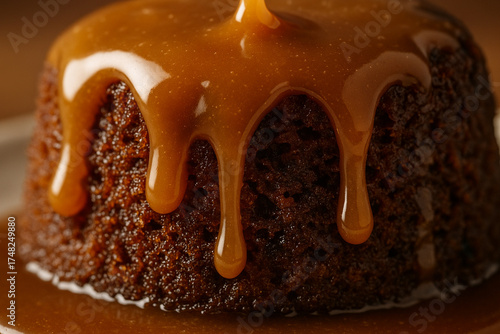 British sticky toffee pudding, warm sauce dripping over sponge cake