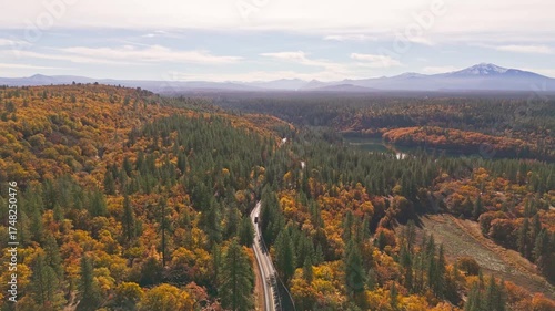 Aerial view of the Volcanic Legacy Scenic Byway landscape with trees and roads creating a beautiful contrast of autumn colors and green, Burney, California, United States.