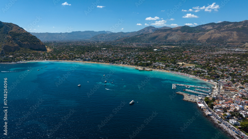 Obraz premium Aerial view of Mondello Beach, located near Palermo, Sicily, Italy. In the foreground, the waters of the Tyrrhenian Sea range from azure to turquoise.