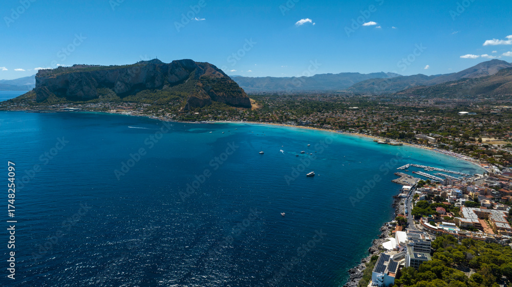 Obraz premium Aerial view of Mondello Beach, located near Palermo, Sicily, Italy. In the foreground, the waters of the Tyrrhenian Sea range from azure to turquoise.