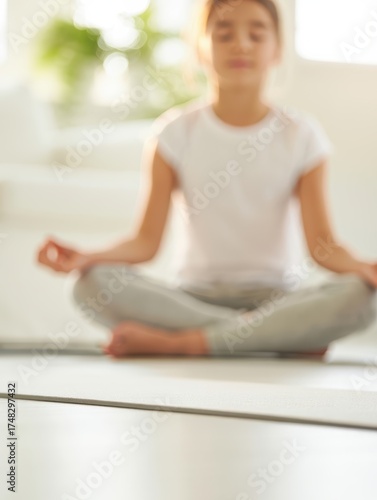 Free Download Woman seated in cross-legged meditation with soft blur background - GFXLoad