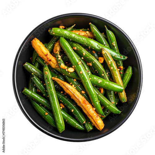 Overhead shot of vibrant green beans seasoned with spices and nuts in a black bowl