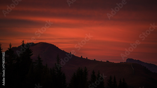 the red sky at the sunset in the austrian mountains 