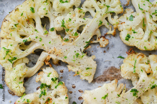 Cauliflower with chimichurri sauce on parchment. Concept of vegan and vegetarian food. Healthy eating. Horizontal orientation. Selective focus. Top view