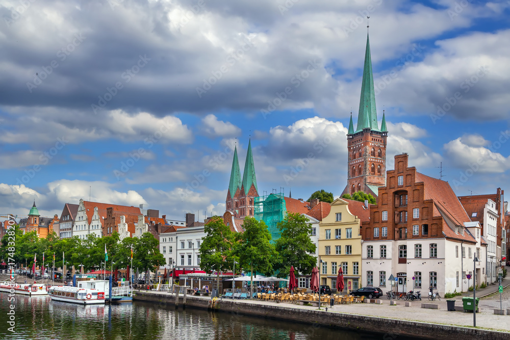 Fototapeta premium Historic houses on the Trave River embankment in Lubeck, Germany