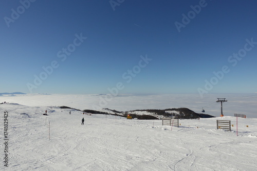 Winter landscapes of the old mountain. Stara Planina Ski Center in winter, ski slopes, clear blue sky above the snowy peaks of Stara Planina 