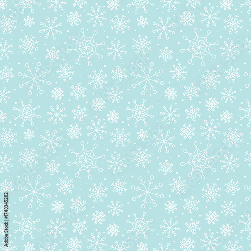 Snowy winter seamless pattern of hand drawn snow flakes on light blue background