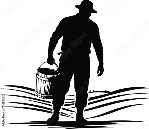Silhouette of a farmer carrying a wooden bucket in a field Keywords: farmer, silhouette, carrying, wooden bucket, pail, agriculture, farming, rural, field, landscape, harvest