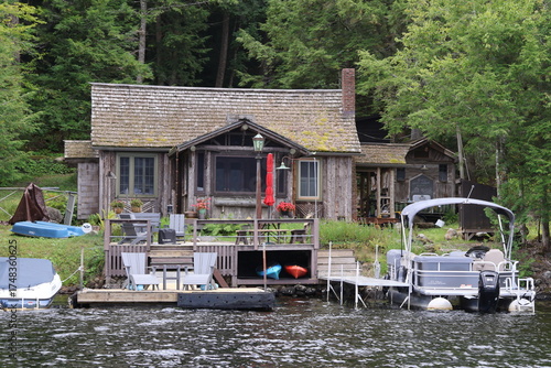 Φωτογραφία A cozy lakefront house with a dock and watercraft
