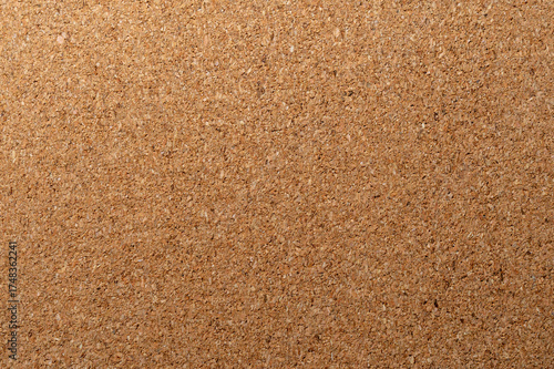 A natural, light brown corkboard or cork material. This textured background is ideal for presentations, concepts, bulletin boards, and environmentally friendly themes.