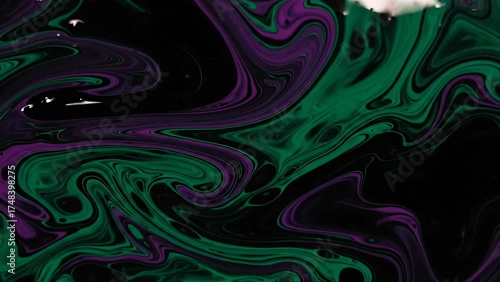 Artistic green and purple fluid swirl creating abstract texture