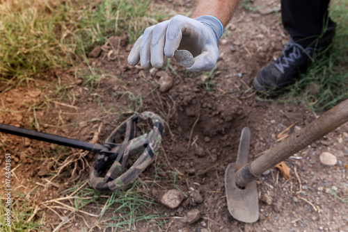 Wallpaper Mural A man's hand with a metal detector holds a found buckle. Torontodigital.ca