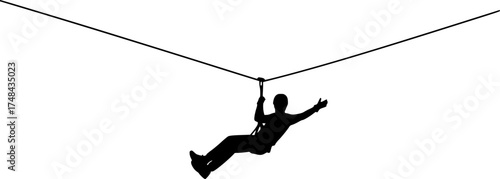 Silhouette of a person ziplining through the air enjoying outdoor adventure activities.
