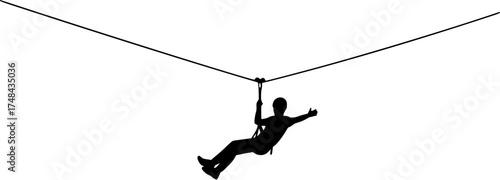 Silhouette of a person ziplining through the air enjoying outdoor adventure activities.
