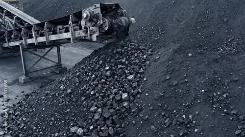 Black Coal Piles from Conveyor Belt in Dark Lighting Coal Industry Scene Mining Operations Power Generation Resource Extraction Industrial Landscape