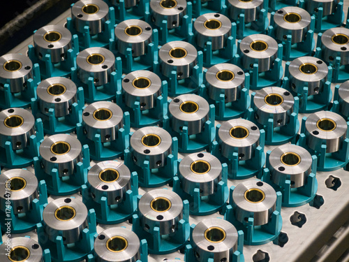 Precision metal components displayed in a factory assembly line ready for quality inspection