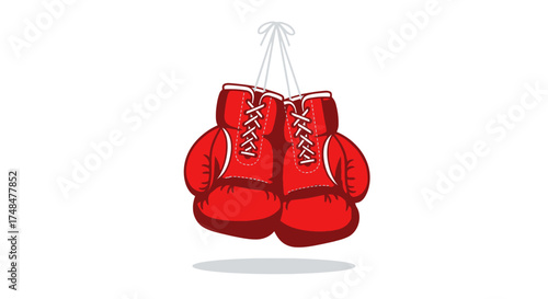 A pair of classic red boxing gloves with white laces hanging together as a symbol of the sport.