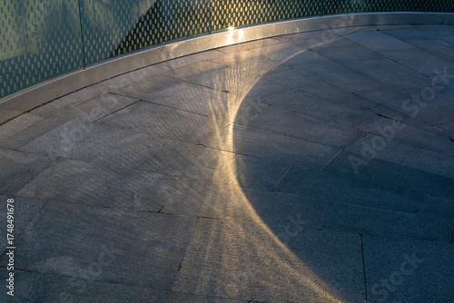 urban background, sunlight and shadow on the stone walkway in the city