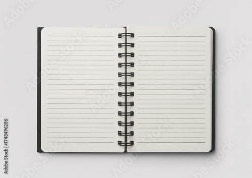 An open black notebook with lined pages, showing handwritten text and a spiral binding, isolated on a white background