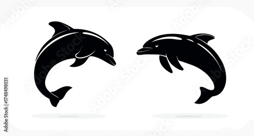 Two stylized black silhouettes of aquatic mammals leaping gracefully. Simple and elegant design on white