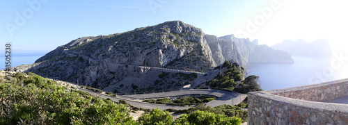 Panoramic view of Cap de Formentor in Mallorca, Balearic Islands. Road to the lighthouse. A Mediterranean landscape with rocky cliffs and a deep blue sea under a clear sky. Spain