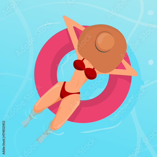 woman with hat relaxing on a round float in a pool or beach