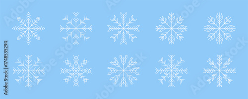 Collection of intricate white snowflakes on blue background for winter decoration