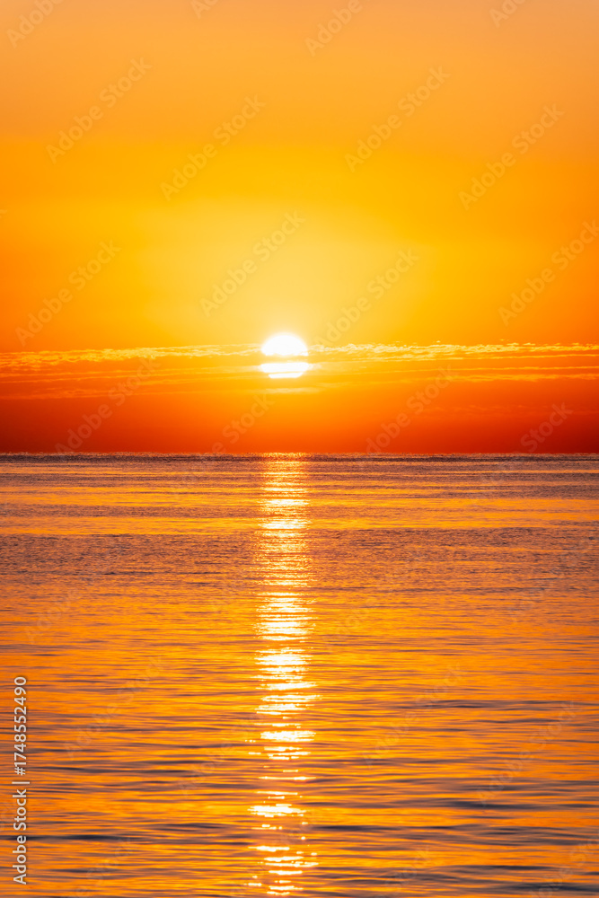 Fototapeta premium Beautiful red and orange sunrise over the sea.