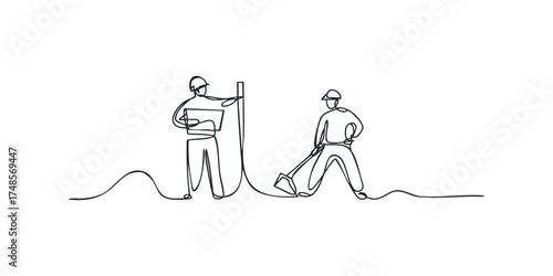 Two construction workers on a site with one digging and the other holding a tablet