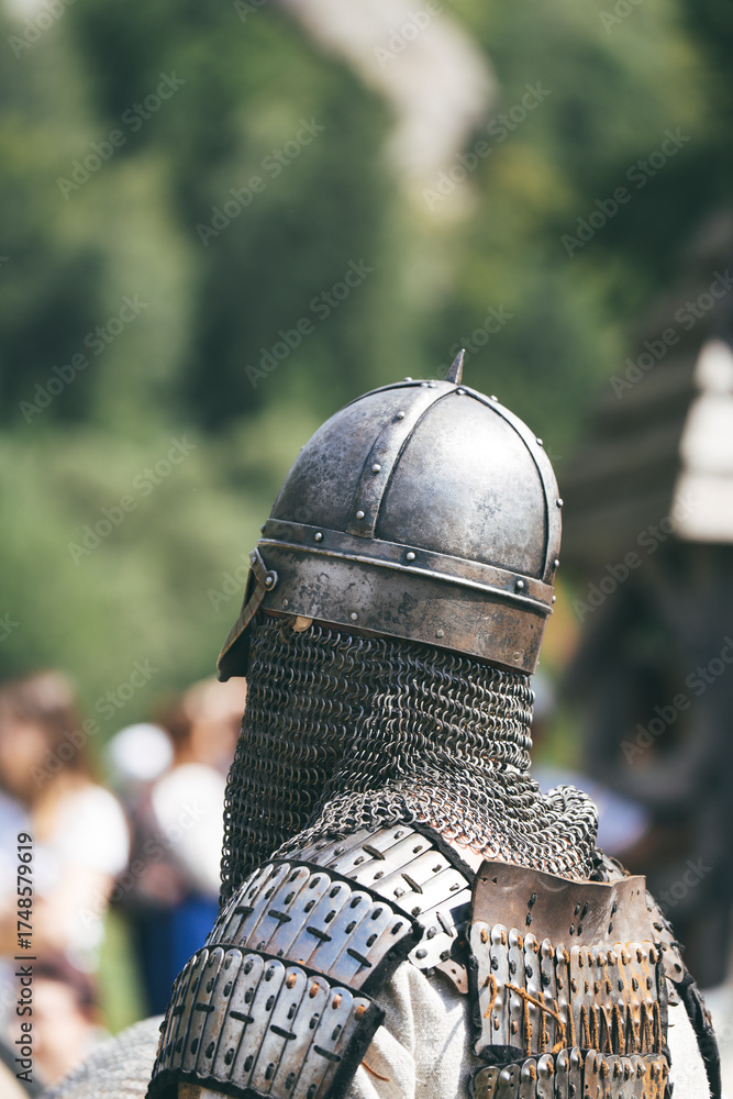 Fototapeta premium knight in helmet and chain mail, ancient knightly armor 
