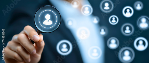 Human Resource Management and Recruitment Concept – Businessman Holding Magnifying Glass over Digital People Icons