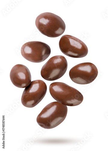 Chocolate covered peanuts flying on a white. Isolated