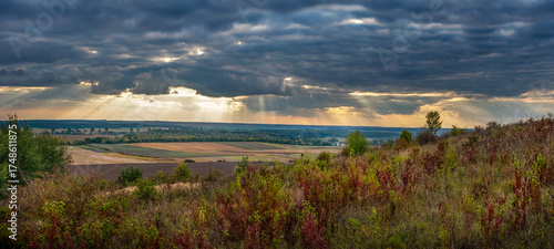 Autumn nature landscape with forests, fields on the horizon under a stormy sk...