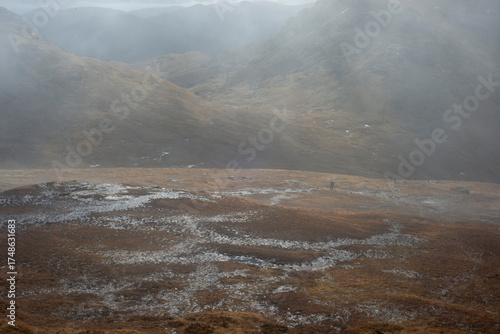 Misty foggy hills mountains in Scotland dramatic landscape hiking tourism active hillwalking