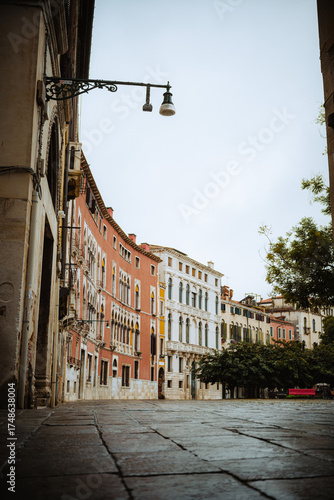 Obraz na plátně A quiet street in Venice, Italy reveals a row of historic buildings with ornate facades