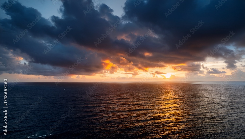 Obraz premium Moody Sunset Sky Over The Ocean Dark Clouds Illuminated With Warm Light Create A Captivating And Atmospheric Scene