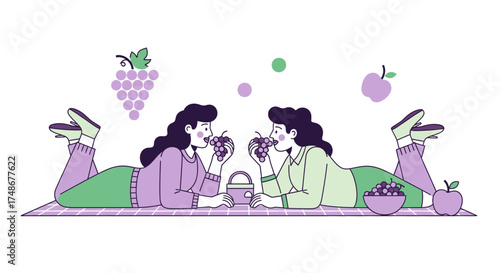 Two Women Sharing Grapes During a Relaxing Picnic on a Sunny Day
