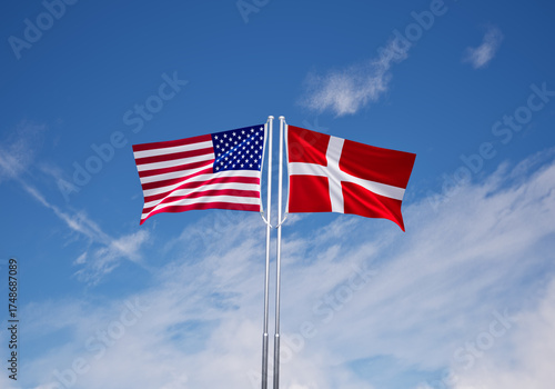 Photography flags of  denmark and United States of America over blue sky background
