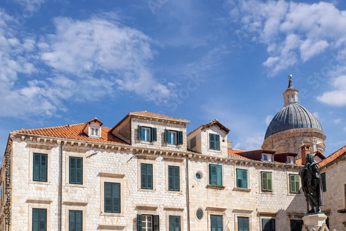 Historic stone buildings with window shutters