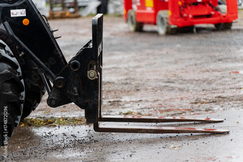 Obraz na plátně Close view of forklift attachment mounted on front loader tractor with metal pal