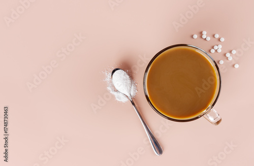 A cup of coffee with milk and a spoonful of natural stevia sweetener. Top view. Copy space.
